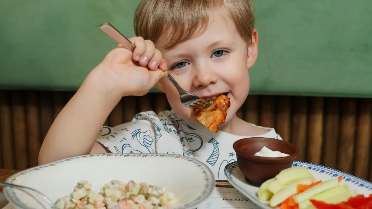 Kid eating healthy snacks for preschoolers at home in Paramus
